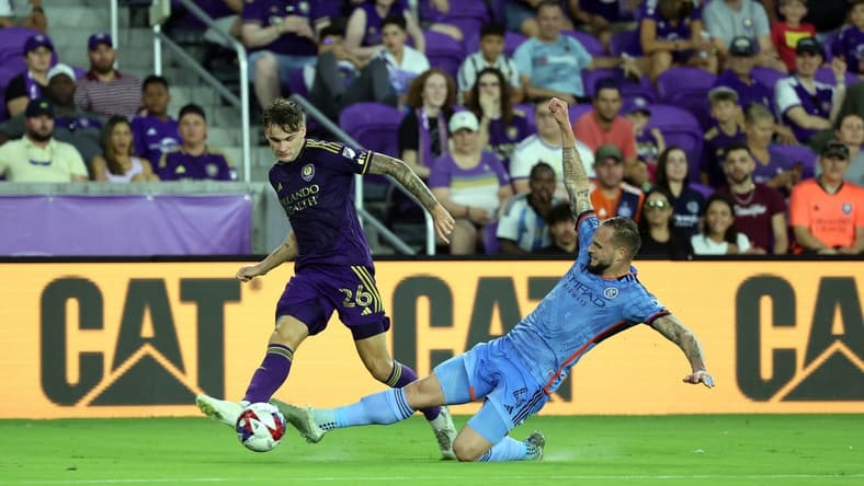 May 17, 2023; Orlando, Florida, USA; Orlando City SC defender Michael Halliday (26) dribbles the ball as New York City FC defender Maxime Chanot (4) defends during the first half at Exploria Stadium. Mandatory Credit: Kim Klement-USA TODAY Sports