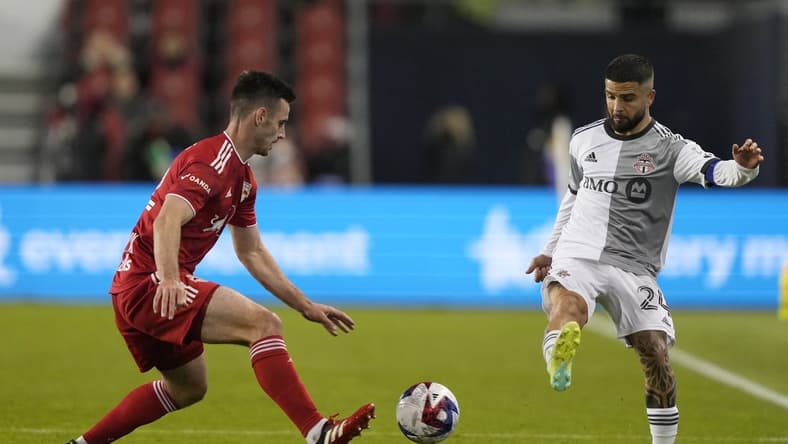 May 17, 2023; Toronto, Ontario, CAN; New York Red Bulls defender Dylan Nealis (12) and Toronto FC forward Lorenzo Insigne (24) battle for the ball in the second half at BMO Field. Mandatory Credit: Kevin Sousa-USA TODAY Sports