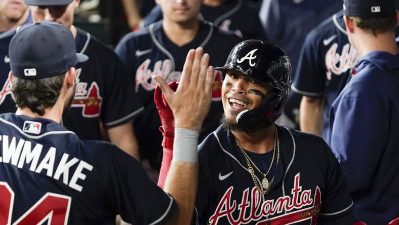 May 17, 2023; Arlington, Texas, USA; Atlanta Braves shortstop Orlando Arcia (11) is greeted in the dugout after hitting a go ahead solo home run against the Texas Rangers during the ninth inning at Globe Life Field. Mandatory Credit: Raymond Carlin III-USA TODAY Sports