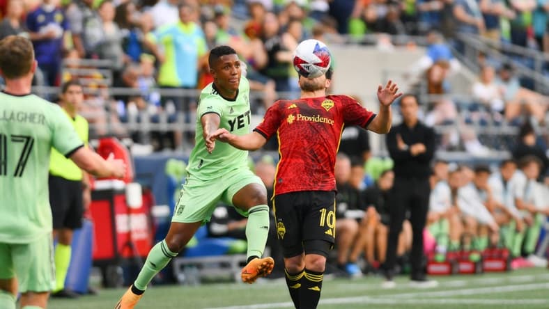 May 17, 2023; Seattle, Washington, USA; Austin FC midfielder Jhojan Valencia (5) and Seattle Sounders midfielder Nicolas Lodeiro (10) both jump for the ball during the first half at Lumen Field. Mandatory Credit: Steven Bisig-USA TODAY Sports