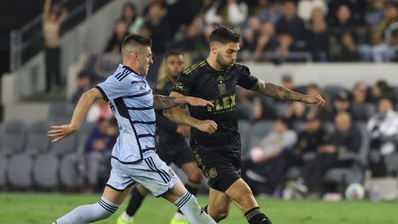 May 17, 2023; Los Angeles, California, USA; Los Angeles FC midfielder Ryan Hollingshead (24) and Sporting Kansas City midfielder Remi Walter (54) fight for the ball during the second half at BMO Stadium. Mandatory Credit: Kiyoshi Mio-USA TODAY Sports