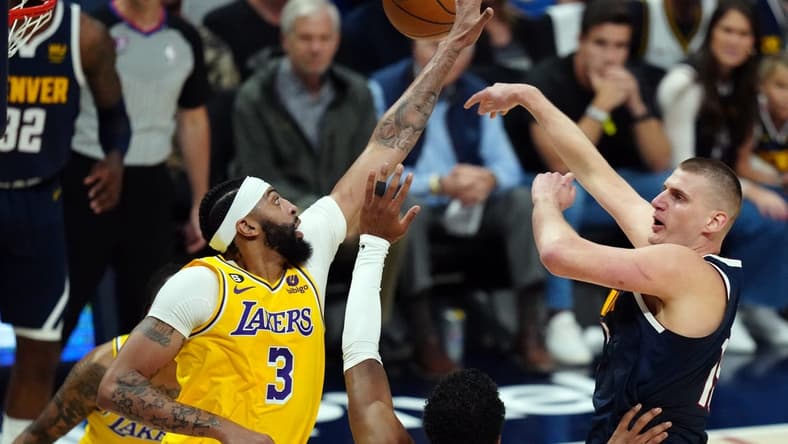 May 18, 2023; Denver, Colorado, USA; Denver Nuggets center Nikola Jokic (15) shoots against Los Angeles Lakers forward Anthony Davis (3) in the first half during game two of the Western Conference Finals for the 2023 NBA playoffs at Ball Arena. Mandatory Credit: Ron Chenoy-USA TODAY Sports