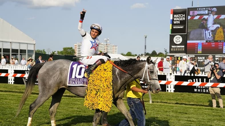 May 19, 2023; Baltimore, Maryland, USA; Taxed with Rafael Bejarno up (10) waves to the crowd after winning the Black Eyed Susan at Pimlico Race Course. Mandatory Credit: Gregory Fisher-USA TODAY Sports