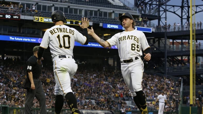 May 19, 2023; Pittsburgh, Pennsylvania, USA; Pittsburgh Pirates left fielder Bryan Reynolds (10) and center fielder Jack Suwinski (65) high-five after both players scored runs against the Arizona Diamondbacks during the fourth inning at PNC Park. Mandatory Credit: Charles LeClaire-USA TODAY Sports
