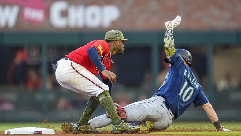 May 19, 2023; Cumberland, Georgia, USA; Seattle Mariners left fielder Jarred Kelenic (10) is tagged out by Atlanta Braves second baseman Ozzie Albies (1) while trying to steal second base during the fourth inning at Truist Park. Mandatory Credit: Dale Zanine-USA TODAY Sports