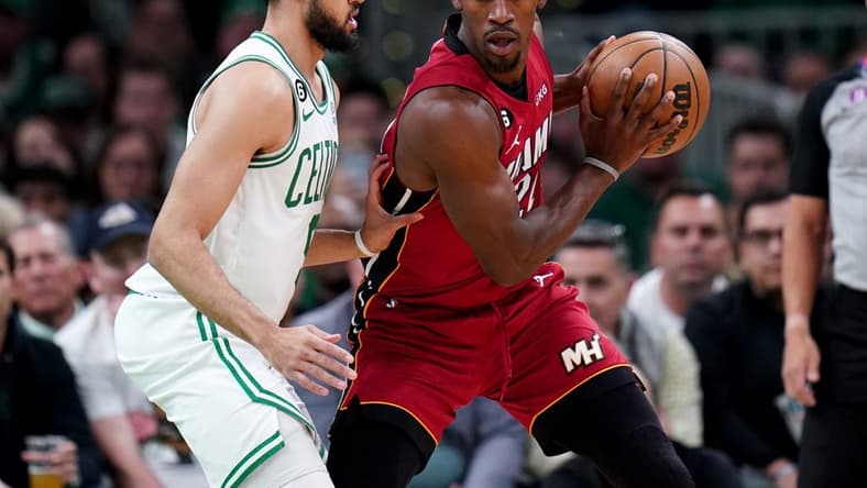 May 19, 2023; Boston, Massachusetts, USA; Miami Heat forward Jimmy Butler (22) looks to pass against Boston Celtics guard Derrick White (9) during the first half of game two of the Eastern Conference Finals for the 2023 NBA playoffs at TD Garden. Mandatory Credit: David Butler II-USA TODAY Sports