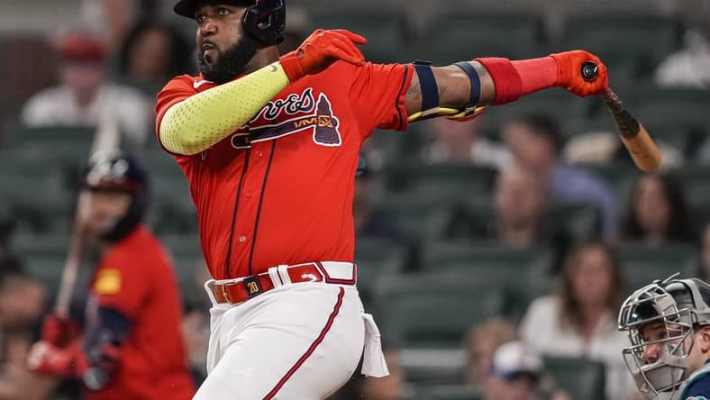 May 19, 2023; Cumberland, Georgia, USA; Atlanta Braves designated hitter Marcell Ozuna (20) singles driving in two runs against the Seattle Mariners during the eighth inning at Truist Park. Mandatory Credit: Dale Zanine-USA TODAY Sports