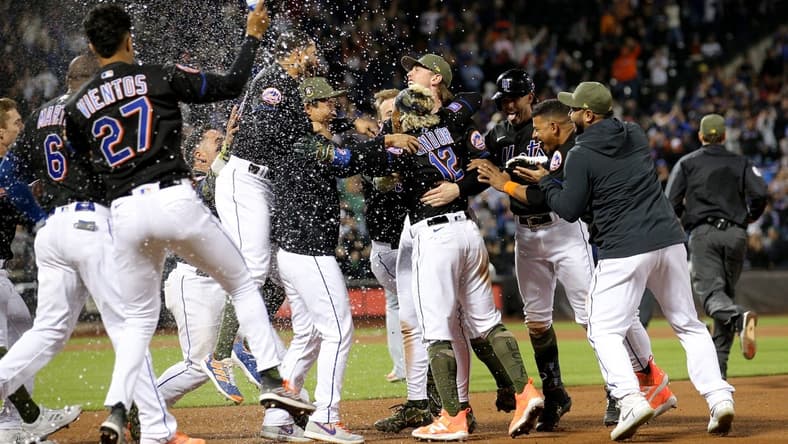 May 19, 2023; New York City, New York, USA; New York Mets shortstop Francisco Lindor (12) celebrates his walkoff RBI single against the Cleveland Guardians with teammates at Citi Field. Mandatory Credit: Brad Penner-USA TODAY Sports