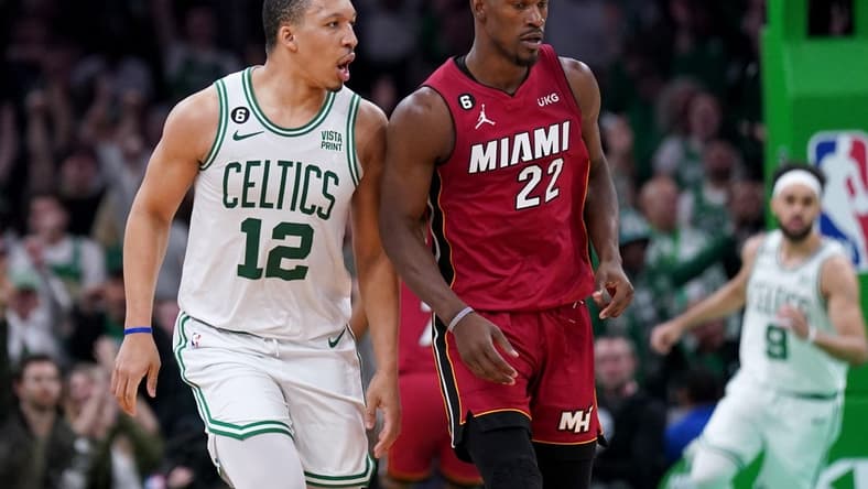 May 19, 2023; Boston, Massachusetts, USA; Boston Celtics forward Grant Williams (12) and Miami Heat forward Jimmy Butler (22) react after a play during the second half of game two of the Eastern Conference Finals for the 2023 NBA playoffs at TD Garden. Mandatory Credit: David Butler II-USA TODAY Sports