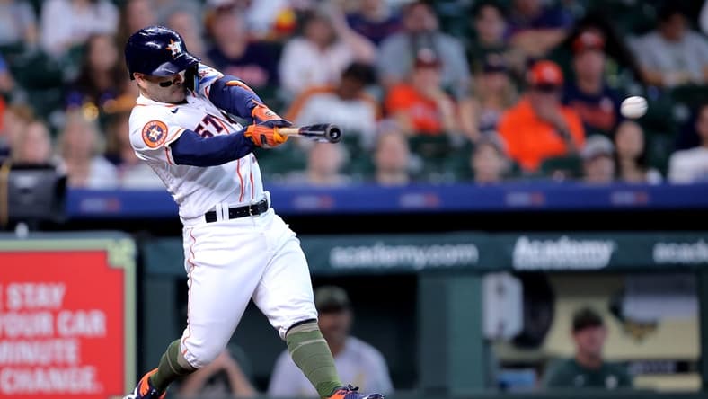 May 20, 2023; Houston, Texas, USA; Houston Astros second baseman Jose Altuve (27) hits a double against the Oakland Athletics during the first inning at Minute Maid Park. Mandatory Credit: Erik Williams-USA TODAY Sports