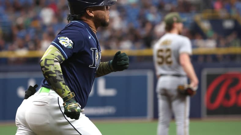 May 20, 2023; St. Petersburg, Florida, USA;Tampa Bay Rays designated hitter Harold Ramirez (43) hits a home run as Milwaukee Brewers starting pitcher Eric Lauer (52) looks on during the first inning at Tropicana Field. Mandatory Credit: Kim Klement-USA TODAY Sports