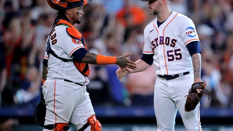 May 20, 2023; Houston, Texas, USA; Houston Astros relief pitcher Ryan Pressly (55) shakes hands with Houston Astros catcher Martin Maldonado (15) after the final out against the Oakland Athletics during the ninth inning at Minute Maid Park. Mandatory Credit: Erik Williams-USA TODAY Sports