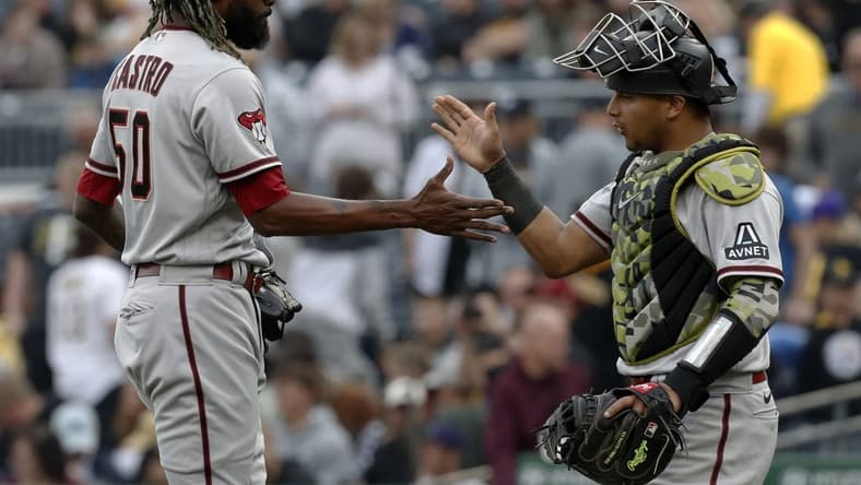 May 20, 2023; Pittsburgh, Pennsylvania, USA;  Arizona Diamondbacks relief pitcher Miguel Castro (50) and catcher Gabriel Moreno (14) shake hands after defeating the Pittsburgh Pirates during at PNC Park.The Diamondbacks won 4-3.  Mandatory Credit: Charles LeClaire-USA TODAY Sports