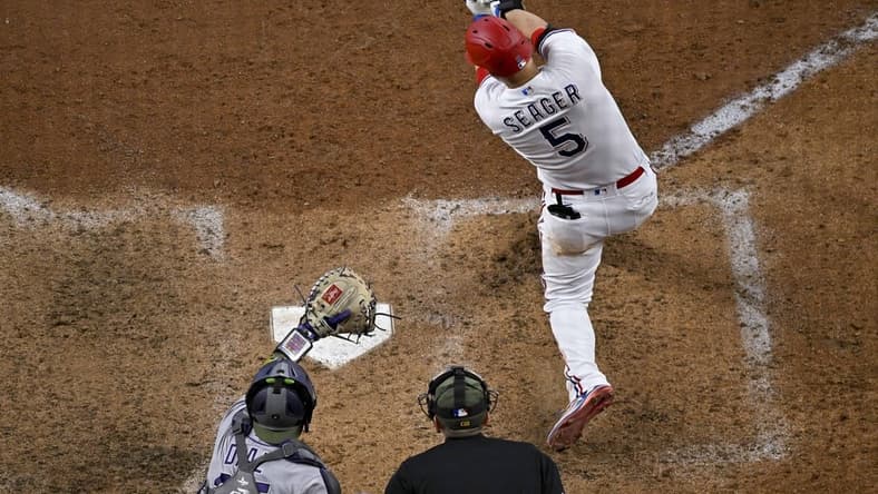 May 20, 2023; Arlington, Texas, USA; Texas Rangers shortstop Corey Seager (5) hits a home run and drives in two runs against the Colorado Rockies during the sixth inning at Globe Life Field. Mandatory Credit: Jerome Miron-USA TODAY Sports