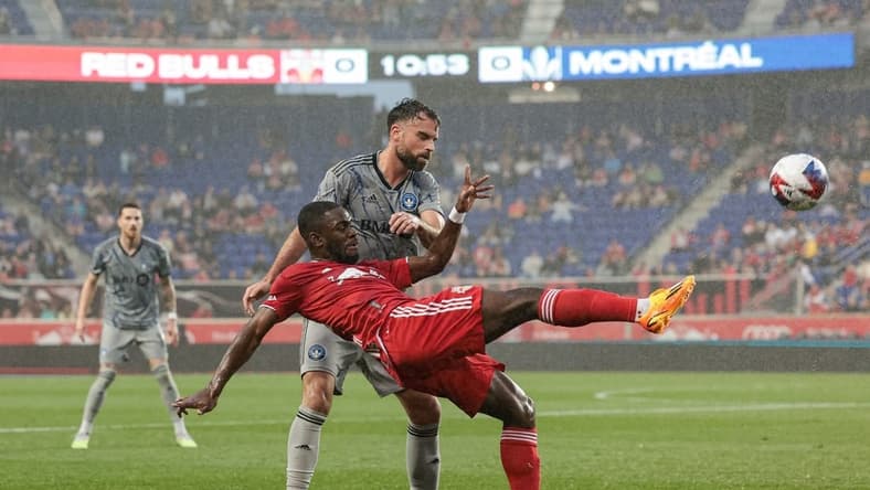 May 20, 2023; Harrison, New Jersey, USA; New York Red Bulls midfielder Dru Yearwood (16) kicks the ball while defended by CF Montreal defender Rudy Camacho (4) during the first half at Red Bull Arena. Mandatory Credit: Vincent Carchietta-USA TODAY Sports