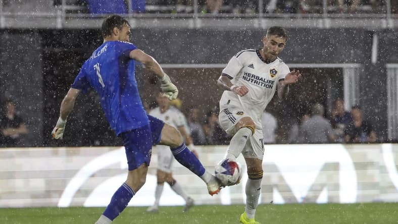 May 20, 2023; Washington, District of Columbia, USA; D.C. United goalkeeper Tyler Miller (1) clears the ball from LA Galaxy midfielder Tyler Boyd (11) in the first half at Audi Field. Mandatory Credit: Geoff Burke-USA TODAY Sports