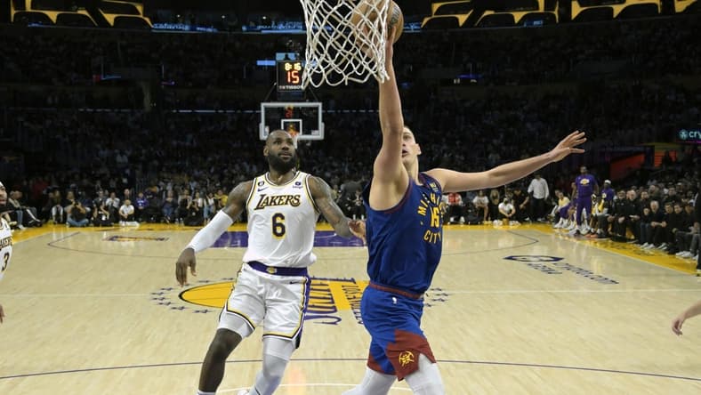 May 20, 2023; Los Angeles, California, USA; Denver Nuggets center Nikola Jokic (15) shoots against Los Angeles Lakers forward LeBron James (6) in the first half during game three of the Western Conference Finals for the 2023 NBA playoffs at Crypto.com Arena. Mandatory Credit: Jayne Kamin-Oncea-USA TODAY Sports