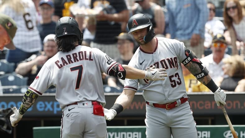 May 21, 2023; Pittsburgh, Pennsylvania, USA; Arizona Diamondbacks first baseman Christian Walker (53) congratulates right fielder Corbin Carroll (7) crossing home plate on a solo home run against the Pittsburgh Pirates during the first inning at PNC Park. Mandatory Credit: Charles LeClaire-USA TODAY Sports
