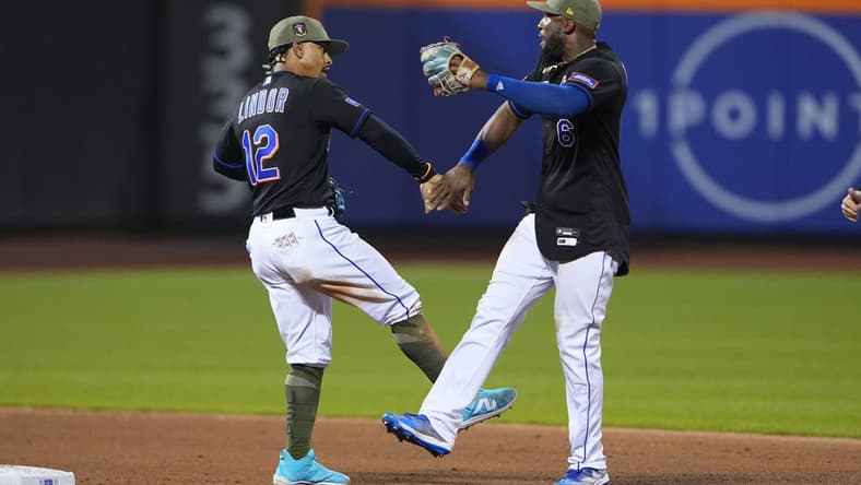 May 21, 2023; New York City, New York, USA; New York Mets shortstop Francisco Lindor (12) and right fielder Starling Marte (6) low five to celebrate the victory after the game against the Cleveland Guardians at Citi Field. Mandatory Credit: Gregory Fisher-USA TODAY Sports