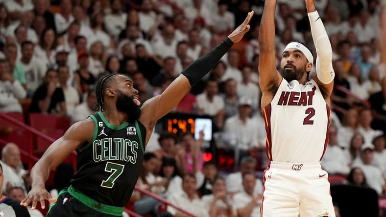 May 21, 2023; Miami, Florida, USA; Miami Heat guard Gabe Vincent (2) shoots against Boston Celtics guard Jaylen Brown (7) during the first half in game three of the Eastern Conference Finals for the 2023 NBA playoffs at Kaseya Center. Mandatory Credit: Jim Rassol-USA TODAY Sports