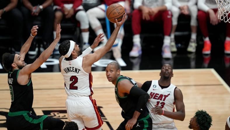 May 21, 2023; Miami, Florida, USA; Miami Heat guard Gabe Vincent (2) shoots against Boston Celtics guard Derrick White (9) during the second half in game three of the Eastern Conference Finals for the 2023 NBA playoffs at Kaseya Center. Mandatory Credit: Jim Rassol-USA TODAY Sports