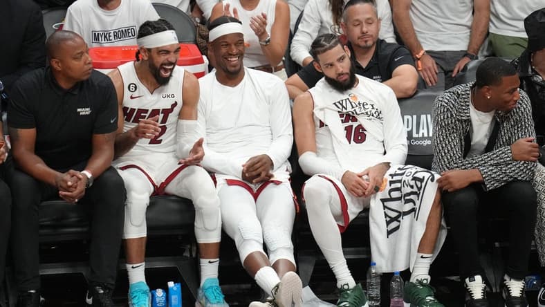 May 21, 2023; Miami, Florida, USA; Miami Heat guard Gabe Vincent (2), forward Jimmy Butler (22) and forward Caleb Martin (16) on the bench during the second half against the Boston Celtics in game three of the Eastern Conference Finals for the 2023 NBA playoffs at Kaseya Center. Mandatory Credit: Jim Rassol-USA TODAY Sports