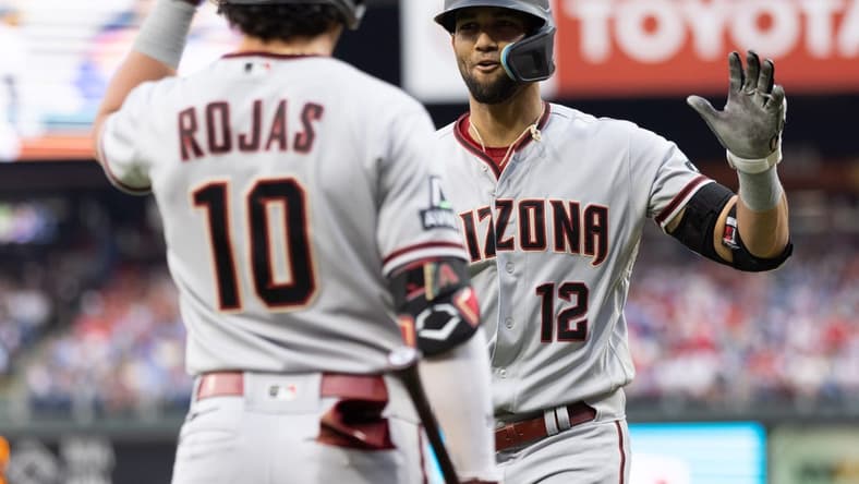 May 22, 2023; Philadelphia, Pennsylvania, USA; Arizona Diamondbacks left fielder Lourdes Gurriel Jr. (12) celebrates with third baseman Josh Rojas (10) after hitting a home run during the second inning against the Philadelphia Phillies at Citizens Bank Park. Mandatory Credit: Bill Streicher-USA TODAY Sports