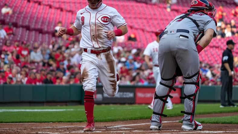 Cincinnati Reds shortstop Matt McLain (9) scores on a Tyler Stephenson single in the first inning of the MLB National League game between the Cincinnati Reds and the St. Louis Cardinals at Great American Ball Park in downtown Cincinnati on Monday, May 22, 2023. The Reds led 4-3 after three innings.