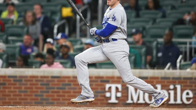 May 22, 2023; Atlanta, Georgia, USA; Los Angeles Dodgers first baseman Freddie Freeman (5) hits a single against the Atlanta Braves in the ninth inning at Truist Park. Mandatory Credit: Brett Davis-USA TODAY Sports