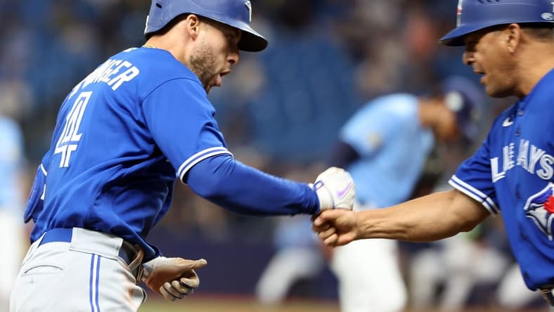 May 23, 2023; St. Petersburg, Florida, USA; Toronto Blue Jays right fielder George Springer (4) celebrates as he runs around the bases after he hits a home run during the third inning against the Tampa Bay Rays at Tropicana Field. Mandatory Credit: Kim Klement-USA TODAY Sports