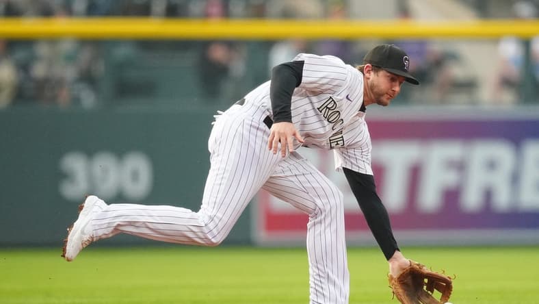 May 23, 2023; Denver, Colorado, USA; Colorado Rockies second baseman Ryan McMahon (24) fields the ball in the first inning against the Miami Marlins at Coors Field. Mandatory Credit: Ron Chenoy-USA TODAY Sports