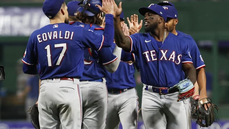 May 23, 2023; Pittsburgh, Pennsylvania, USA; Texas Rangers starting pitcher Nathan Eovaldi (17) and right fielder Adolis Garcia (right) celebrate after defeating the Pittsburgh Pirates at PNC Park. Mandatory Credit: Charles LeClaire-USA TODAY Sports