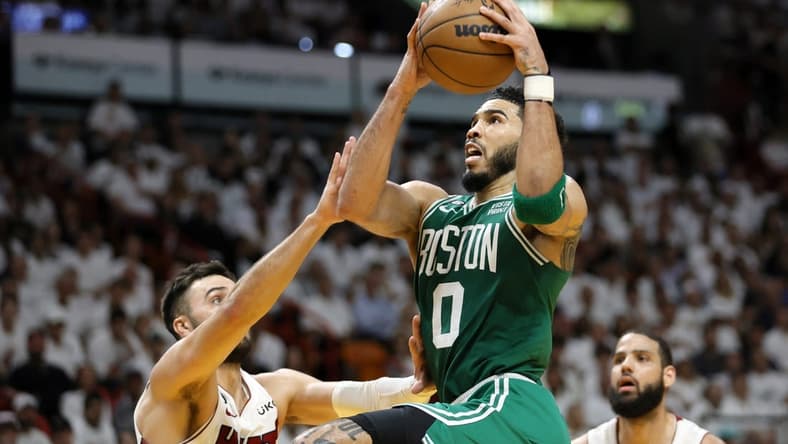 May 23, 2023; Miami, Florida, USA; Boston Celtics forward Jayson Tatum (0) shoots against Miami Heat guard Max Strus (31) in the third quarter during game four of the Eastern Conference Finals for the 2023 NBA playoffs at Kaseya Center. Mandatory Credit: Sam Navarro-USA TODAY Sports