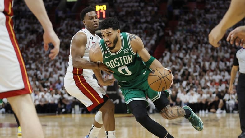 May 23, 2023; Miami, Florida, USA; Boston Celtics forward Jayson Tatum (0) shoots against Miami Heat guard Kyle Lowry (7) in the third quarter during game four of the Eastern Conference Finals for the 2023 NBA playoffs at Kaseya Center. Mandatory Credit: Sam Navarro-USA TODAY Sports