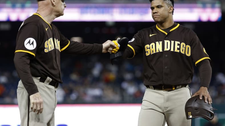 May 23, 2023; Washington, District of Columbia, USA; San Diego Padres left fielder Juan Soto (22) celebrates with Padres third base coach Matt Williams (18) against the Washington Nationals during a pitching change after hitting a single in the fifth inning at Nationals Park. Mandatory Credit: Geoff Burke-USA TODAY Sports