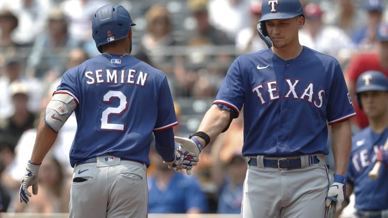 May 24, 2023; Pittsburgh, Pennsylvania, USA; Texas Rangers designated hitter Corey Seager (right) greets second baseman Marcus Semien (2) after hitting a solo home run against the Pittsburgh Pirates during the first inning at PNC Park. Mandatory Credit: Charles LeClaire-USA TODAY Sports