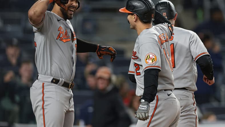 May 24, 2023; Bronx, New York, USA; Baltimore Orioles second baseman Adam Frazier (12) celebrates with right fielder Anthony Santander (25) after hitting a three run home run during the seventh inning against the New York Yankees at Yankee Stadium. Mandatory Credit: Vincent Carchietta-USA TODAY Sports