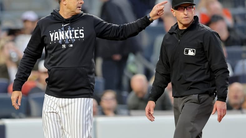 May 25, 2023; Bronx, New York, USA; New York Yankees manager Aaron Boone (17) argues with first base umpire Chris Guccione (68) during the third inning against the Baltimore Orioles at Yankee Stadium. Mandatory Credit: Brad Penner-USA TODAY Sports