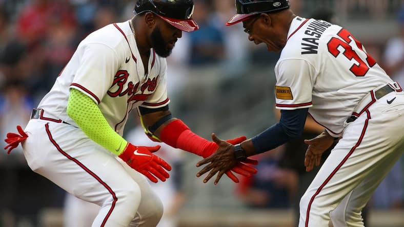 May 25, 2023; Atlanta, Georgia, USA; Atlanta Braves designated hitter Marcell Ozuna (20) celebrates with third base coach Ron Washington (37) after a home run against the Philadelphia Phillies in the second inning at Truist Park. Mandatory Credit: Brett Davis-USA TODAY Sports
