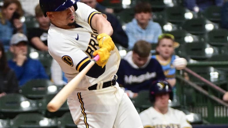 May 25, 2023; Milwaukee, Wisconsin, USA; Milwaukee Brewers shortstop Willy Adames (27) hits a double in the fourth inning against the San Francisco Giants at American Family Field. Mandatory Credit: Benny Sieu-USA TODAY Sports