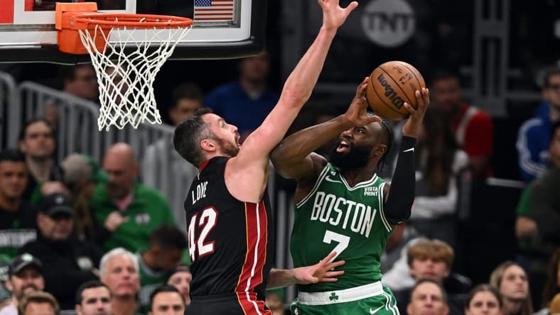 May 25, 2023; Boston, Massachusetts, USA; Boston Celtics guard Jaylen Brown (7) shoots against Miami Heat forward Kevin Love (42) in the fourth quarter during game five of the Eastern Conference Finals for the 2023 NBA playoffs at TD Garden. Mandatory Credit: Brian Fluharty-USA TODAY Sports