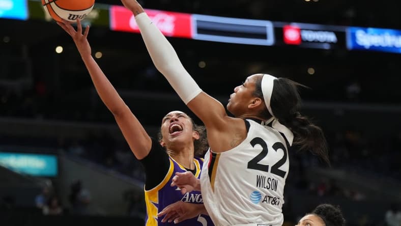 May 25, 2023; Los Angeles, California, USA; LA Sparks guard Kianna Smith (5) shoots the ball against Las Vegas Aces forward A'ja Wilson (22) during the first half at Crypto.com Arena. Mandatory Credit: Kirby Lee-USA TODAY Sports