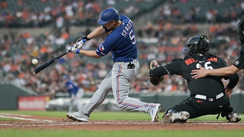 May 26, 2023; Baltimore, Maryland, USA;  Texas Rangers shortstop Corey Seager (5) hits a fourth inning grand slam off Baltimore Orioles starting pitcher Grayson Rodriguez (30) at Oriole Park at Camden Yards. Mandatory Credit: Tommy Gilligan-USA TODAY Sports