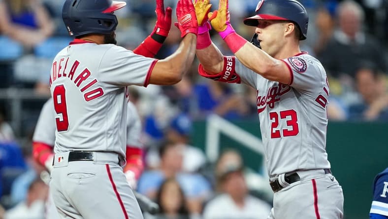 May 26, 2023; Kansas City, Missouri, USA; Washington Nationals third baseman Jeimer Candelario (9) congratulated left fielder Corey Dickerson (23) after hitting a home run during the sixth inning against the Kansas City Royals at Kauffman Stadium. Mandatory Credit: Jay Biggerstaff-USA TODAY Sports