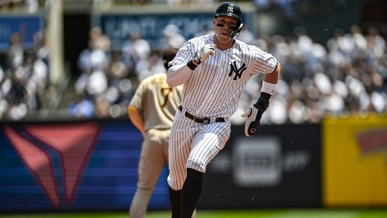 May 27, 2023; Bronx, New York, USA; New York Yankees center fielder Aaron Judge (99) advances to third base on a single by New York Yankees first baseman Anthony Rizzo (48) during the first inning against the San Diego Padres at Yankee Stadium. Mandatory Credit: John Jones-USA TODAY Sports