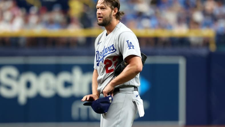May 27, 2023; St. Petersburg, Florida, USA; Los Angeles Dodgers starting pitcher Clayton Kershaw (22) reacts after he balked and puts the transmitter in his hat during the first inning against the Tampa Bay Rays at Tropicana Field. Mandatory Credit: Kim Klement-USA TODAY Sports
