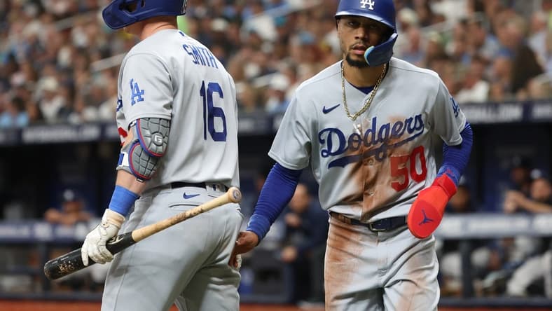 May 27, 2023; St. Petersburg, Florida, USA; Los Angeles Dodgers right fielder Mookie Betts (50) is congratulated after he scored during the fifth inning against the Tampa Bay Rays at Tropicana Field. Mandatory Credit: Kim Klement-USA TODAY Sports
