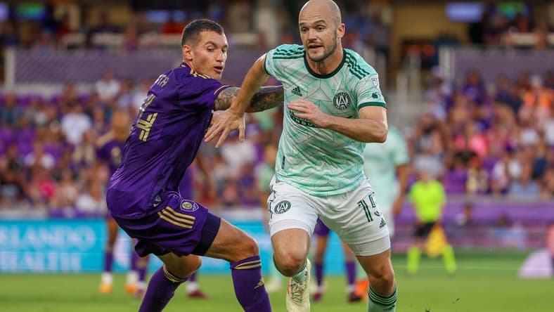 May 27, 2023; Orlando, Florida, USA;  Orlando City SC defender Kyle Smith (24) and Atlanta United FC defender Andrew Gutman (15) fight for possession in the first half at Exploria Stadium. Mandatory Credit: Nathan Ray Seebeck-USA TODAY Sports