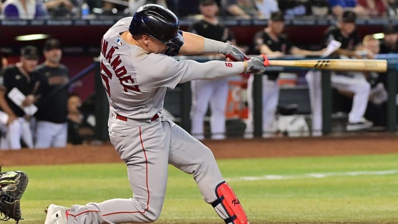 May 27, 2023; Phoenix, Arizona, USA; Boston Red Sox shortstop Enrique Hernandez (5) hits an RBI single against the Arizona Diamondbacks in the fourth inning at Chase Field. Mandatory Credit: Matt Kartozian-USA TODAY Sports