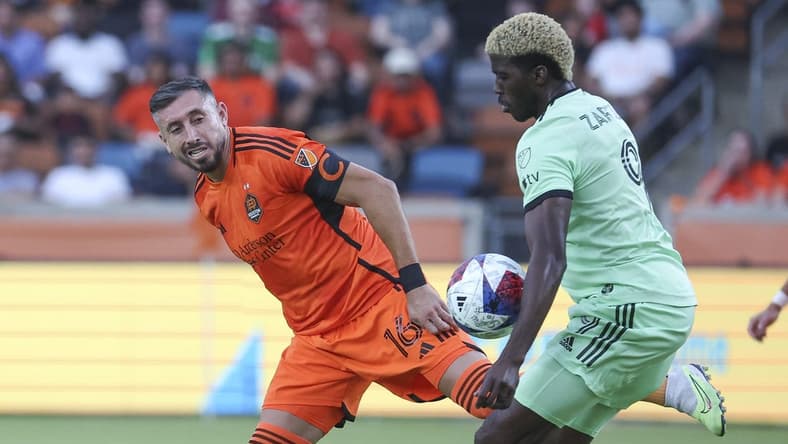 May 27, 2023; Houston, Texas, USA; Houston Dynamo FC midfielder Hector Herrera (16) and Austin FC forward Gyasi Zardes (9) battle for the ball during the first half at Shell Energy Stadium. Mandatory Credit: Troy Taormina-USA TODAY Sports